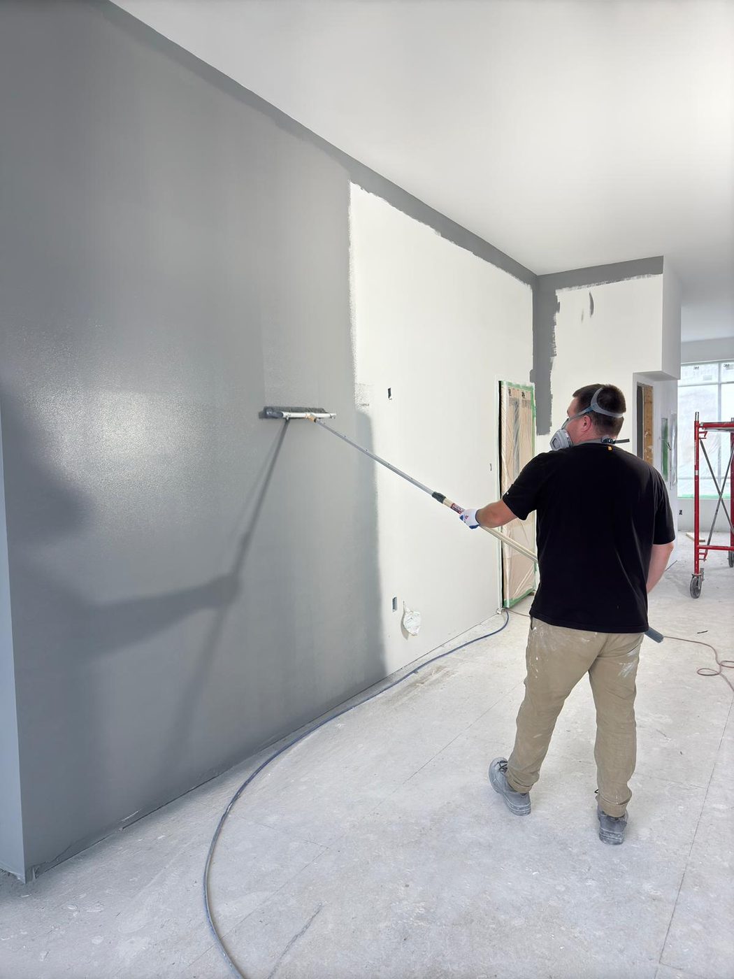 Painting a large interior wall with a roller