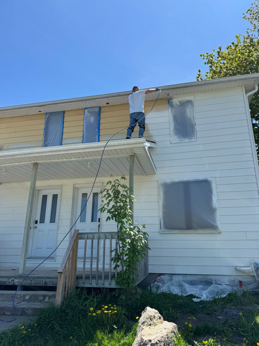 Spray painting a home exterior