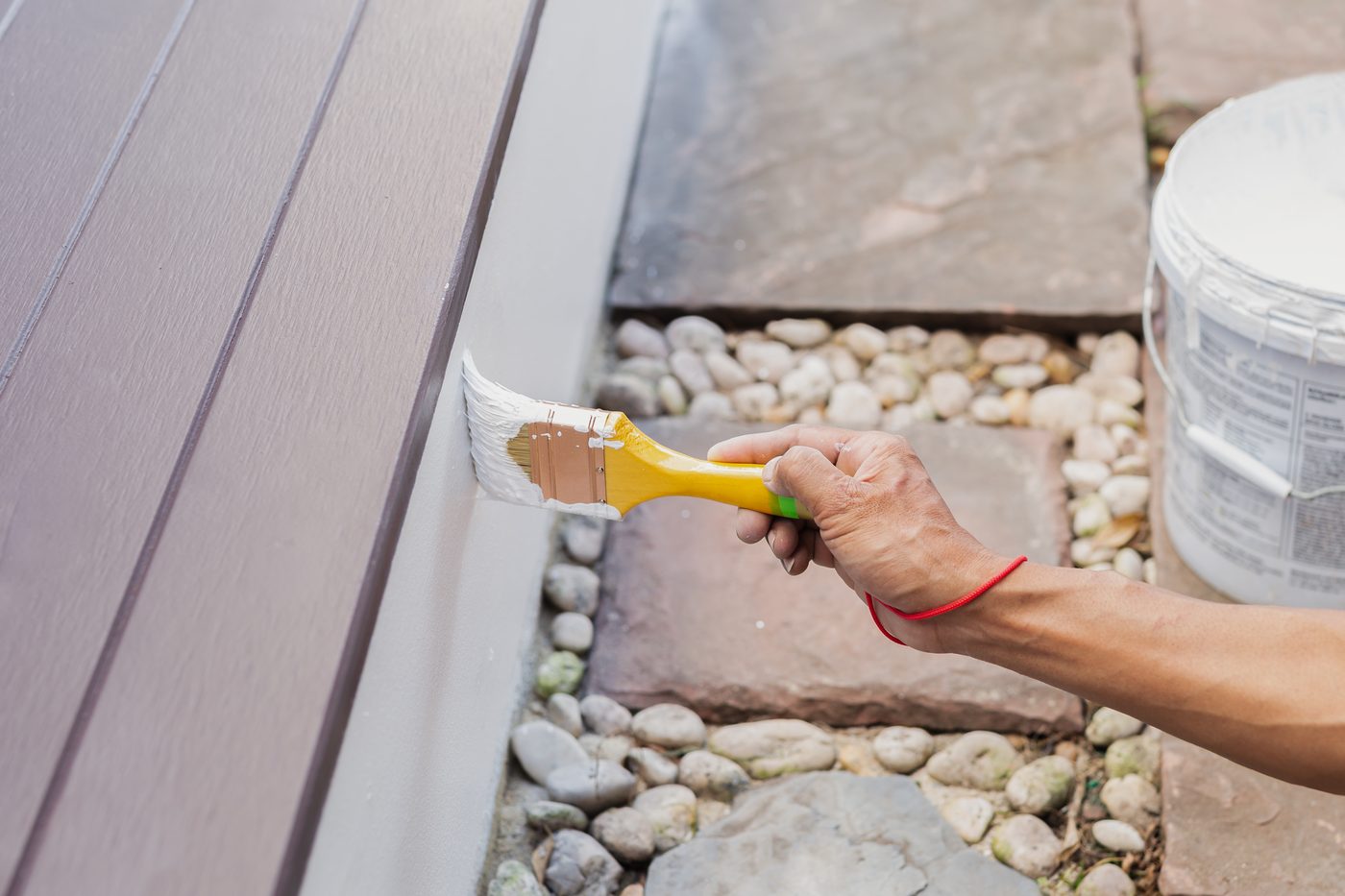 Painting fresh trim on a home exterior