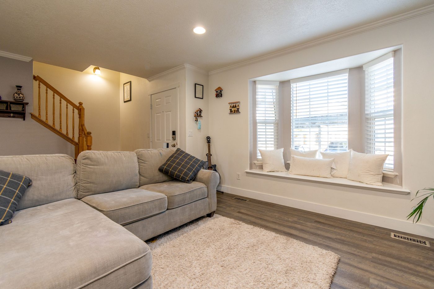 Bright finished living room with a bay window